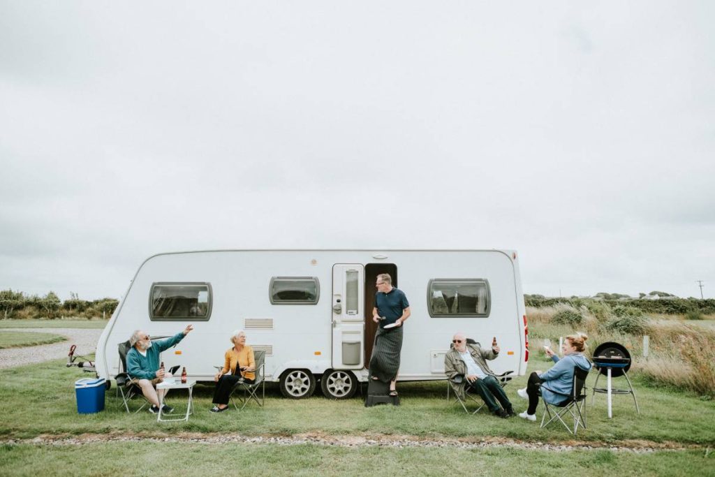 Senior people enjoying outside a trailer